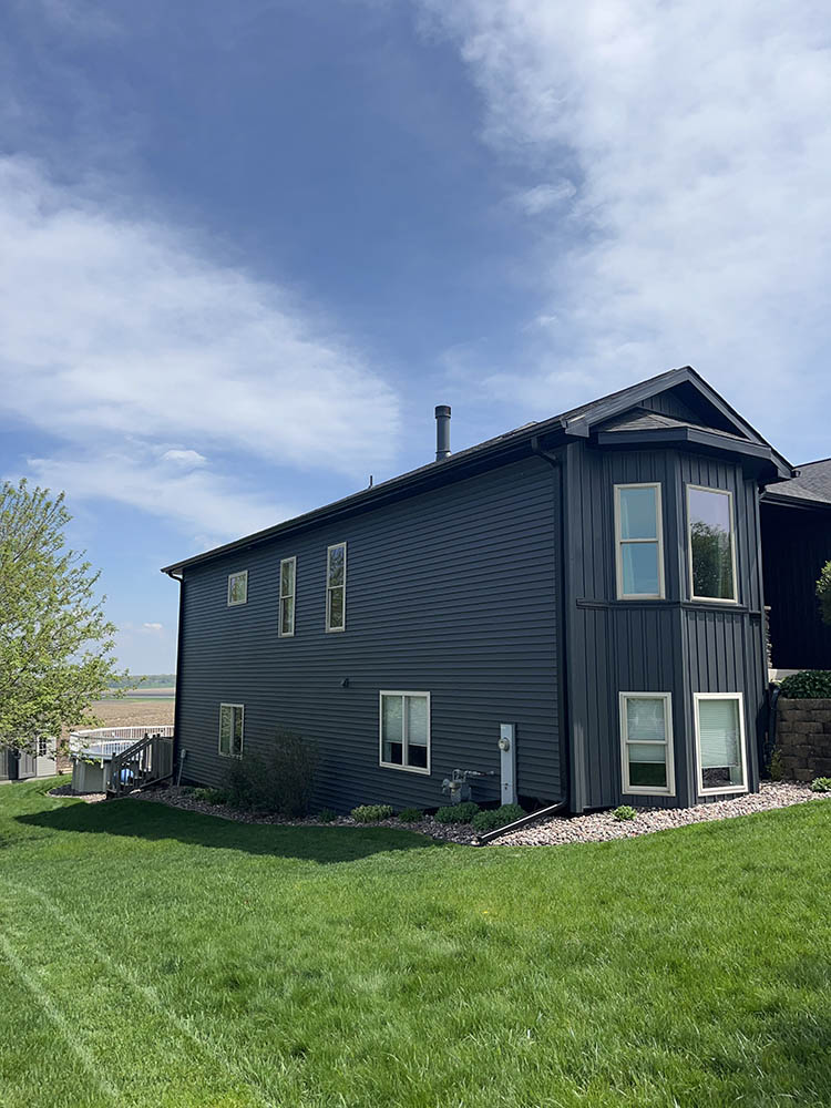 Crew installing insulated vinyl siding on a two-story Madison Wisconsin home