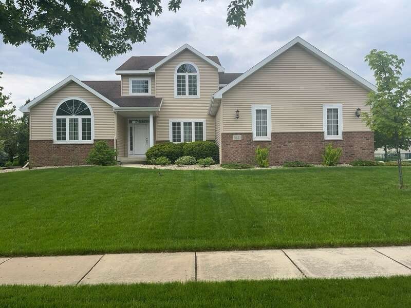 A well-maintained home with a combination of brick and siding exterior
