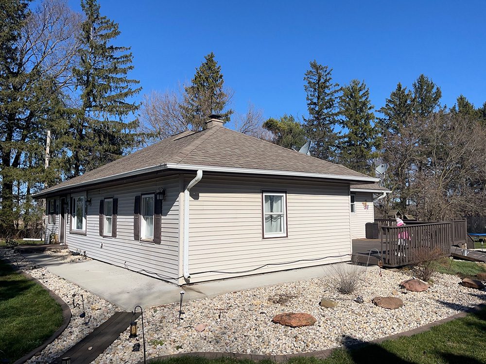 A well-maintained home with a sloped roof and siding visible