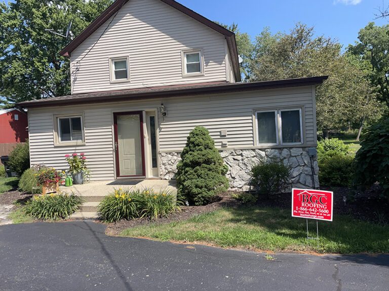 Two-storey home with new lap siding and white trim