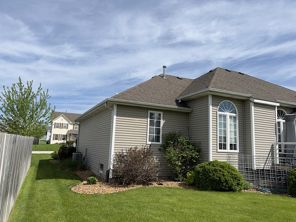 A well-maintained home showcasing its roof and siding in a suburban setting