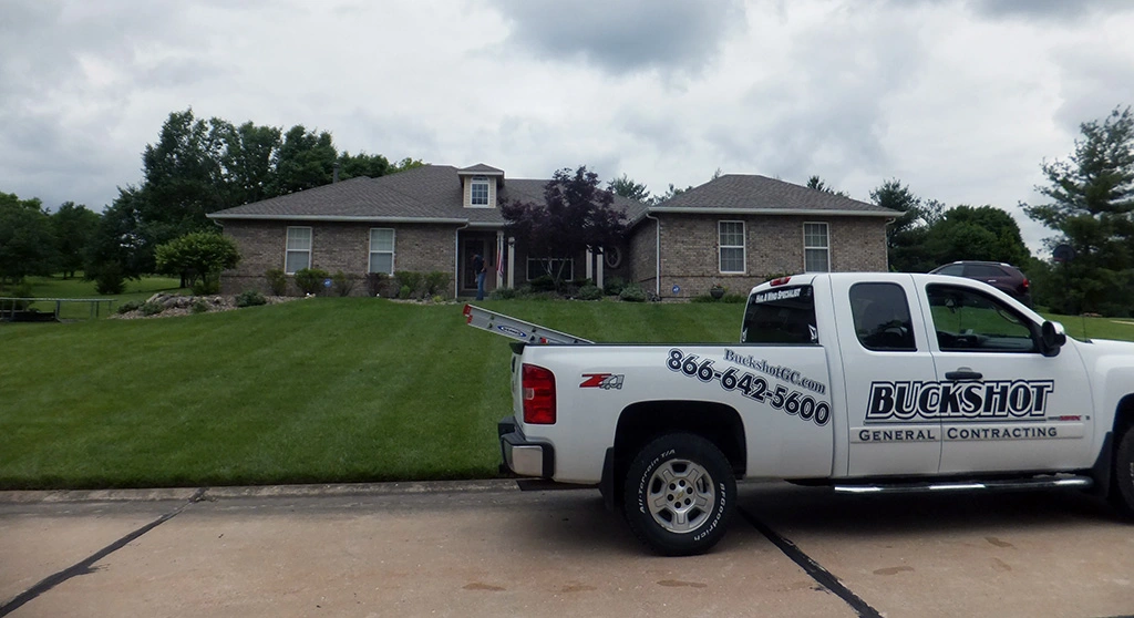 A Buckshot General Contracting truck parked in front of a residential home