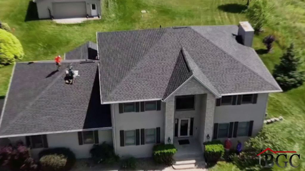 Buckshot crew working on the shingle roof of a two-story home